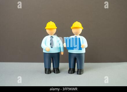 Engineers with blueprints, design and planning, construction concept. Architectural development, technical drawings, project management and teamwork f Stock Photo