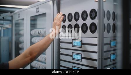 IT Technician Inspect Active Cooling Fans and Evaluate Airflow Performance. Routine Thermal Monitoring, Hardware Maintenance Prevent Server Overheating, Ensure Continuous Cloud Infrastructure Uptime. Stock Photo