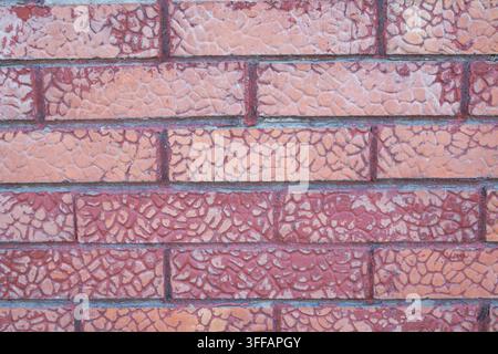 Weathered red brick wall with crackled surface and contrasting mortar joints Stock Photo