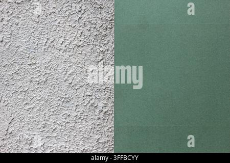 Vertical split architectural background showing rough white stucco plaster texture on the left and smooth pastel green painted panel on the right. Stock Photo