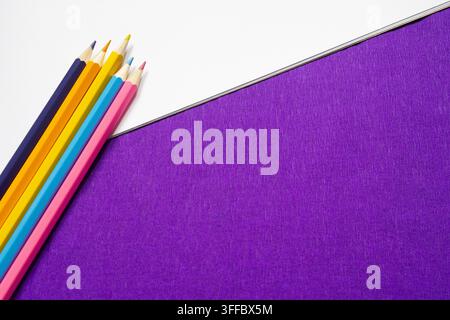 Colorful Pencils on Purple and White Background with Copy Space Stock Photo