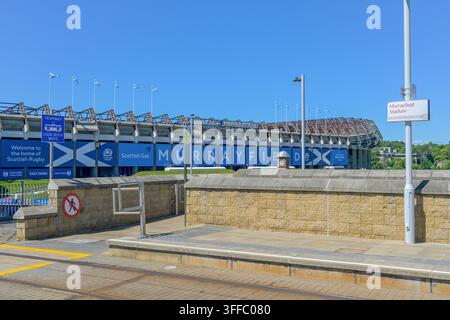 Edinburgh Trams Murrayfield tram stop with Murrayfield stadium in close proximity beneath a cloudless blue sky. Stock Photo