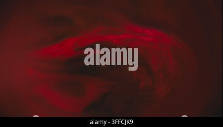 Defocused paint wave. Glitter spill. Red color texture ink water shiny fluid particles on dark black abstract art background. Stock Photo
