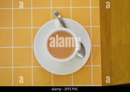 Cup of tea on a table with yellow grid pattern Stock Photo