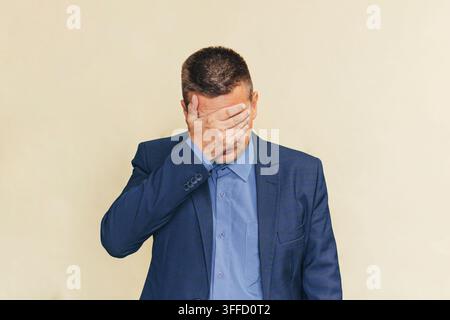 close up employee hand gesture palm up over face and head for stress, major of depressive disorder concept. businessman is ashamed. Stock Photo