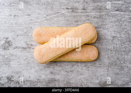 Sugar coated ladyfinger biscuits stacked on rustic gray background with copy space Stock Photo