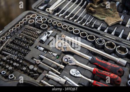 Mechanic tool set with ratchets sockets bits and wrenches in auto repair shop. Professional equipment represents car maintenance and vehicle repair Stock Photo