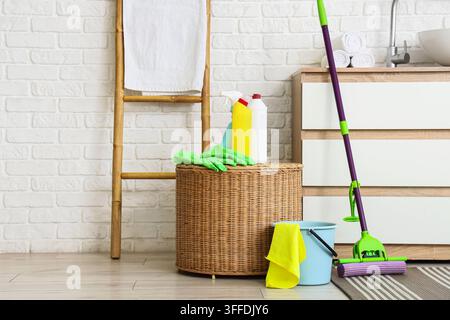 House cleaning and hygiene, cleaning supplies with mop and detergent bottles in a modern bathroom for home maintenance and sanitation service Stock Photo