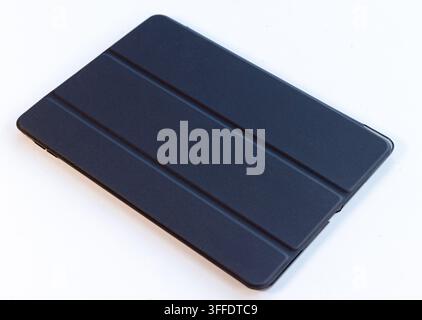A dark grey tablet protective cover is shown on a white background Stock Photo