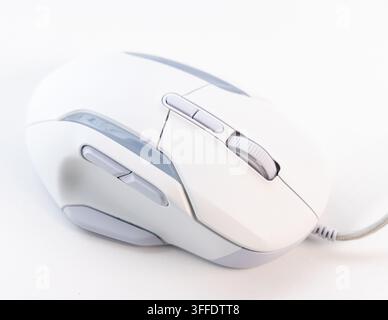 A sleek white wired gaming mouse is on a clean white surface Stock Photo