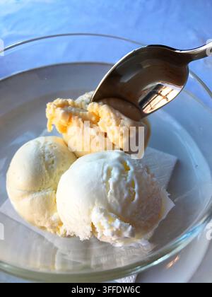 Eating three flavours ice creams: honey, cheese and olive oil. Spain. Stock Photo