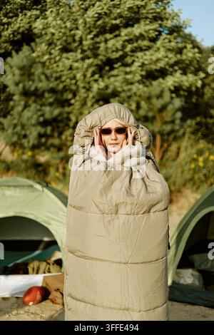 Portrait of Woman Wrapped in Sleeping Bag at Campsite Stock Photo