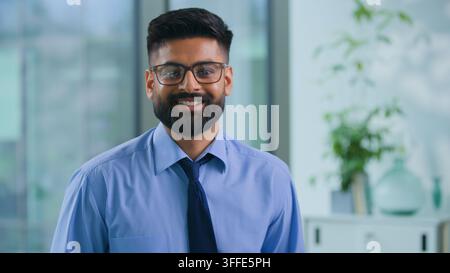 Portrait happy smiling Arabian businessman working in office Muslim business man work in company joyful Indian executive in glasses bearded stylish Stock Photo