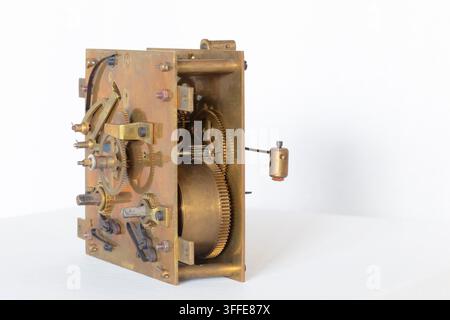 Old metal clockwork with mechanical parts, gears, cogs and screws Stock Photo