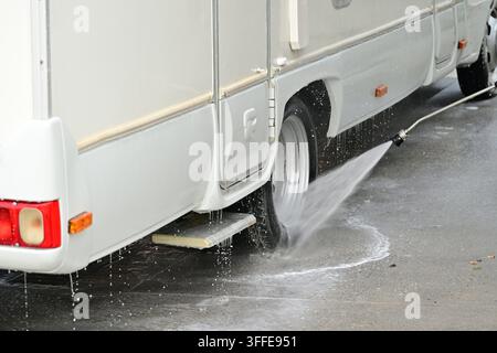 Close-up of RV wheel and lower side cleaned with pressure washer spray Stock Photo