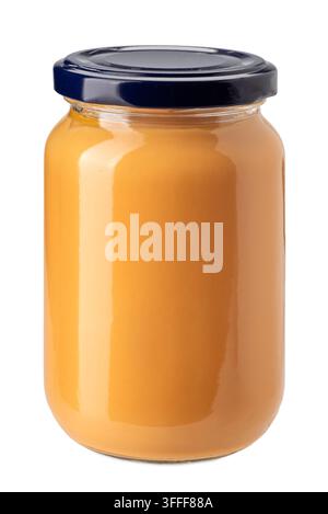 Creamy peanut butter in a clear glass jar with a dark blue lid, isolated on white clipping path included. Smooth organic nut spread, healthy breakfast Stock Photo