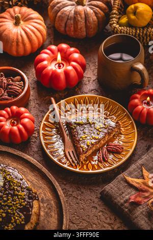Delicious slice of chocolate nut cake with pecans and pistachios on a festive table Stock Photo