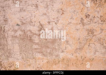 A high-resolution grunge textured wall background featuring a rough, weathered surface with natural cracks, stains, and aged detail. Ideal for design Stock Photo