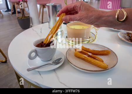 Churros the traditional Spanish and Portuguese fried pastry made from choux-like dough that is piped into hot oil and coated with cinnamon sugar Stock Photo