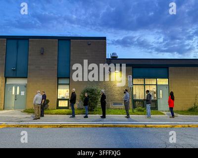 Voters line up before a polling site opens to cast their ballots in ...
