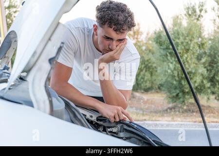 Young man frustrated by car breakdown problem Stock Photo
