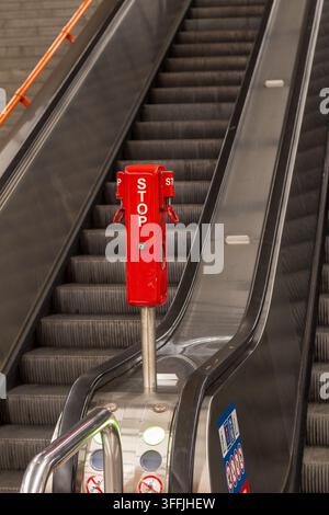 Vienna, Austria July 17, 2026 red emergency stop control beside a metro escalator in an underground public transport station. Stock Photo
