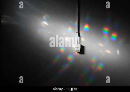 wall plug with steel electric wire tube on the concrete wall in light and shade Stock Photo