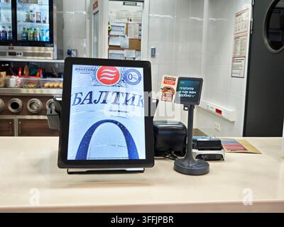 Kirov, Russia - April 06, 2026: A customer uses a payment terminal at a ...