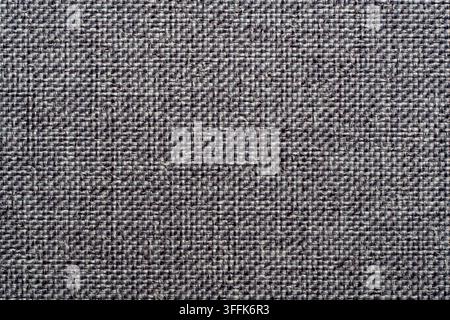 Grey upholstery fabric texture background with canvas weave. Close up gray textile material canvas background abstract dark melange cotton or linen pa Stock Photo