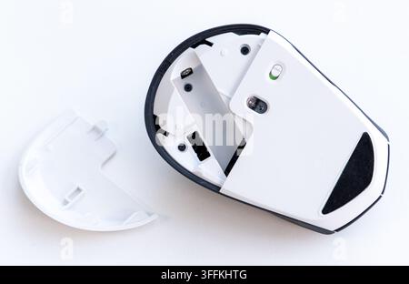 The underside of a wireless mouse with its battery cover removed Stock Photo