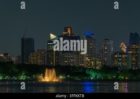 Night view of Bangkok skyline and illuminated high-rise buildings along ...