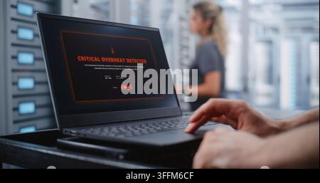Male Data Center Engineer Responds to Critical Overheating Alert Through Linux CLI, Monitoring Server Health and Entering Emergency Commands While Sur Stock Photo
