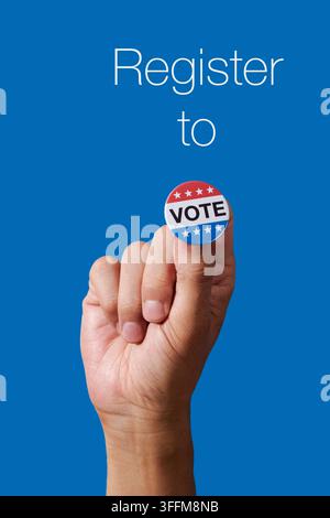 held between the fingers of a man, a vote badge completes the phrase register to vote, forming a direct voter registration message against a blue back Stock Photo