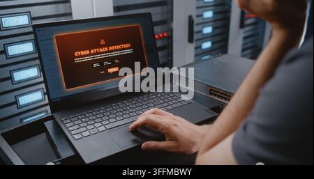 Male IT Specialist Responds To Cyber Attack Alert Using Linux Command Line, Reviewing Telemetry and Performing Emergency Recovery Actions During Criti Stock Photo