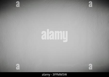 hi resolution photograph of white color painted concrete wall background wallpaper in spot light with dark shadow conners vignette Stock Photo