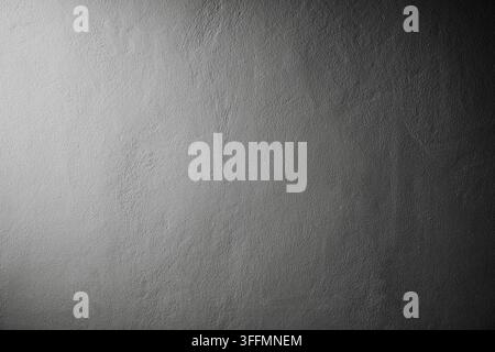 white color painted concrete wall in spot light and dark shadow on the opposite side Stock Photo