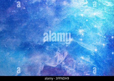Decorative paper texture featuring layered blue tones, cloudy abstract shapes and scattered star-like details with a dreamy celestial appearance. Stock Photo