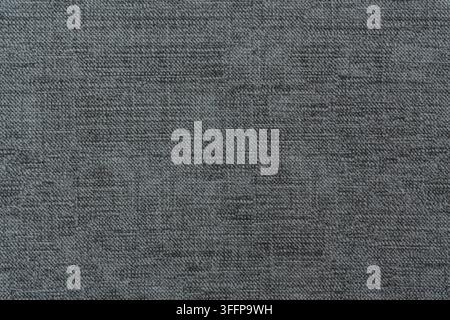 Detailed close-up view of dark gray woven fabric showing natural textile fibers and plain weave structure. Charcoal gray color perfect for modern desi Stock Photo