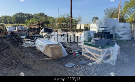 A variety of construction materials and debris are piled together in an outdoor setting at Brierley Homes, Kirkby Malzeard, UK. Stock Photo