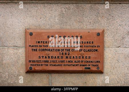 Historical plaque detailing imperial linear measures placed by Glasgow Corporation in 1882. Stock Photo