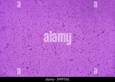 Close-up of a weathered purple painted concrete wall with subtle cracks, stains, and rough grain, creating an abstract textured background for design, Stock Photo