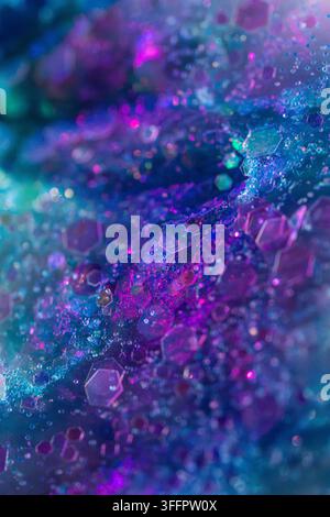 Abstract macro background of translucent hexagonal crystals, glitter particles, and liquid droplets in luminous blue, cyan, purple, and pink neon tone Stock Photo