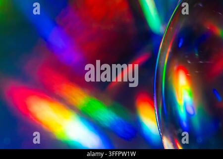 Abstract futuristic background with vivid rainbow light refraction through a glass lens, creating colorful prismatic reflections, glowing streaks, and Stock Photo