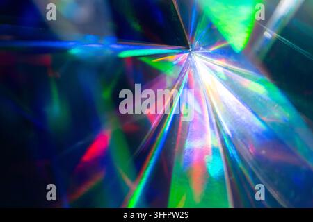 Abstract futuristic tech background with a bright prismatic light burst, rainbow spectrum reflections, and refracted beams radiating across a dark spa Stock Photo