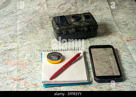 Planning outdoor adventure using map, compass, and technology Stock Photo