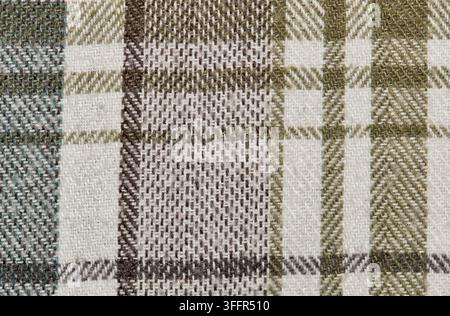 Brown and green tartan flannel shirt pattern background with plaid clothing design. Stock Photo