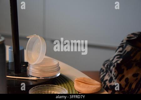 Compact Powder and Makeup Applicator on a Table Stock Photo
