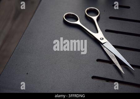 Professional Hairdressing Scissors on a Black Table Stock Photo