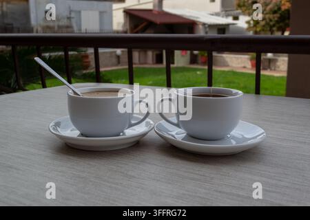 Two Cups of Coffee and Tea on Outdoor Table Stock Photo