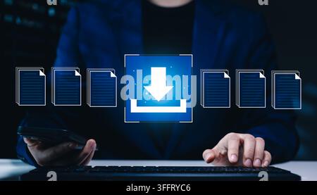 File download and data transfer technology concept. Businesswoman typing keyboard and using smartphone with digital file icons and download symbol rep Stock Photo